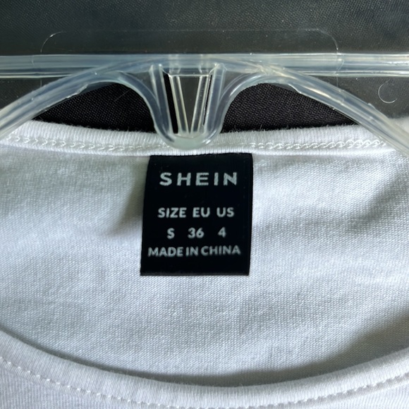 this top is from shein, it is a white shirt with blue, black, and tan-orange top - Picture 2 of 3